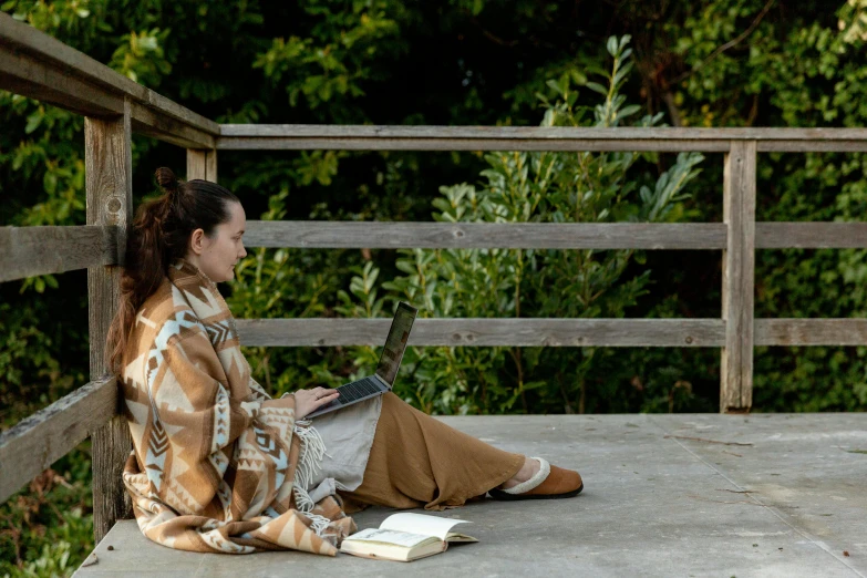 a woman sitting on a bench using a laptop computer, inspired by Camille Corot, unsplash, plein air, brown cloak, wearing a haori, scientific study, full body in shot