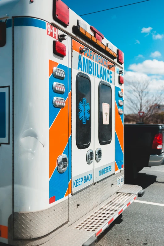 an ambulance is parked in a parking lot, pexels, orange and cyan paint decals, profile picture, taken on iphone 14 pro, first aid kit