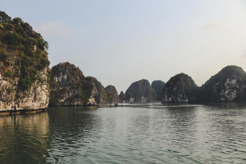 a large body of water surrounded by mountains, happening, vietnam, rock arcs, vacation photo, fan favorite