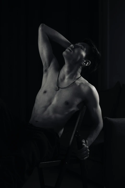 a shirtless man sitting on a chair in the dark, inspired by Jean-Jacques Henner, pexels contest winner, asian male, shirtless :: high detail, julian ope, abs