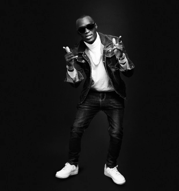 a black and white photo of a man in a jacket, an album cover, by derek zabrocki, pexels, lyco art, album art young thug, doing a sassy pose, kevin hart, fighting pose