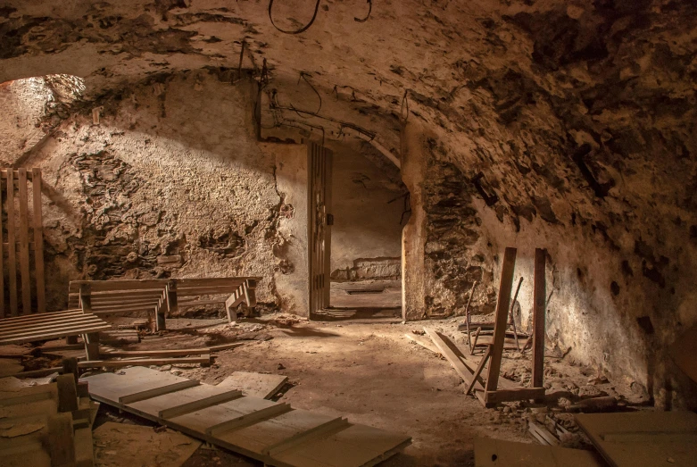 a room that has a bunch of benches in it, an album cover, by Thomas Häfner, pexels contest winner, arte povera, ancient caves, photo from the dig site, thumbnail, brown