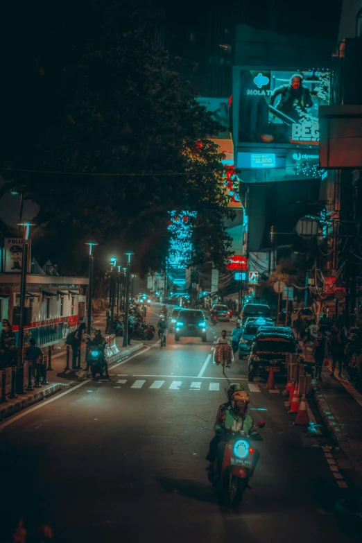 a person riding a motorcycle down a street at night, pexels contest winner, colombo sri lanka cityscape, neon lights lots of trees, cyberpunk streets in japan, square