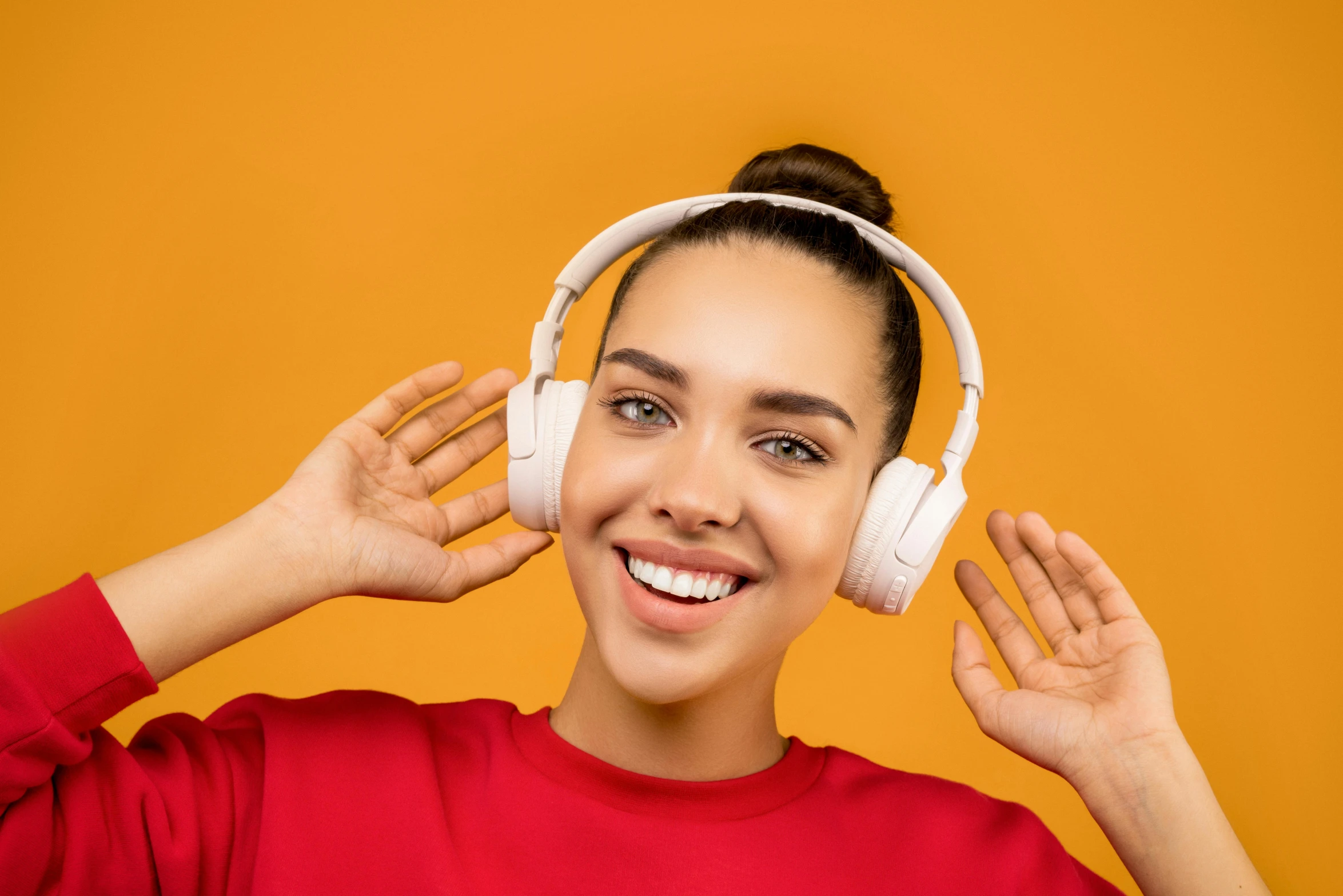 a woman in a red shirt is listening to headphones, trending on pexels, orange halo around her head, avatar image, dimples, promotional photo