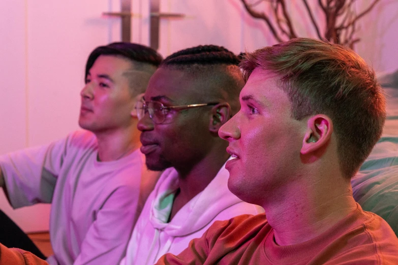 a group of men sitting next to each other on a couch, pexels contest winner, colored lighting, diverse haircuts, profile image, featuring pink brains