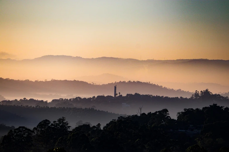 a view of a hill with a clock tower in the distance, by Peter Churcher, unsplash contest winner, sumatraism, morning haze, straya, panorama distant view, tamborine