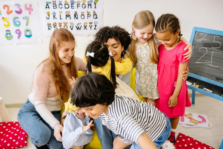 a group of young children sitting on top of a floor