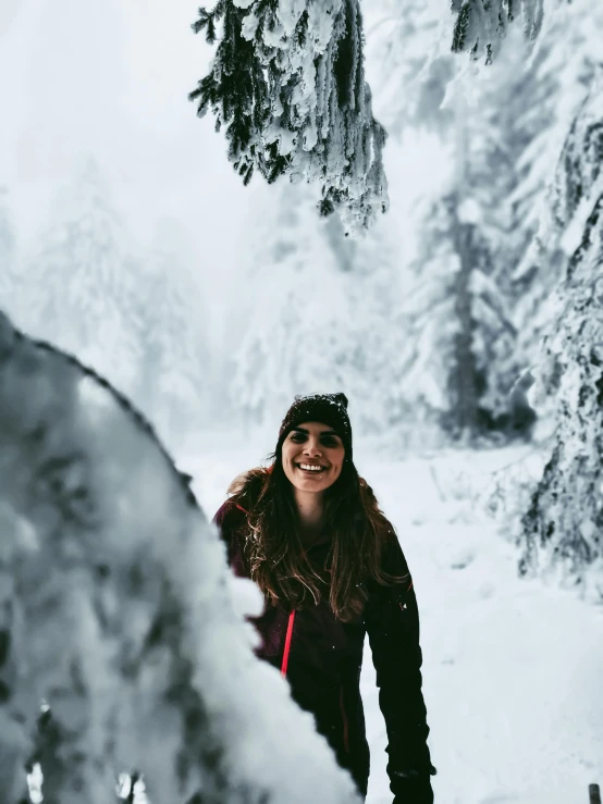 a woman riding skis down a snow covered slope, a photo, by Julia Pishtar, pexels contest winner, portrait of a smiling, standing in a grotto, happy trees, grinning lasciviously