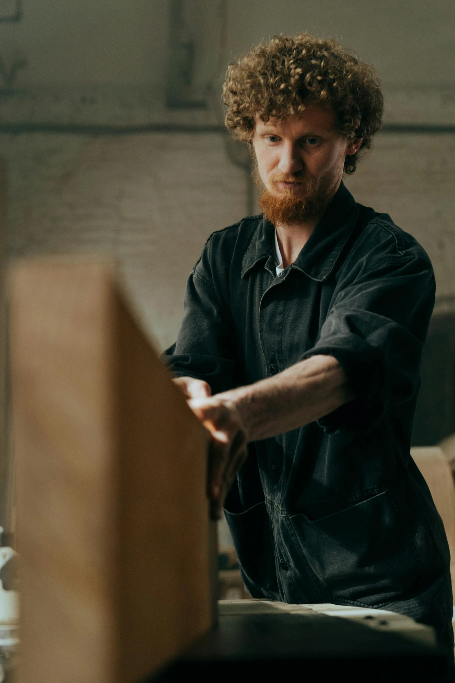 a man that is standing in a room, by Thomas Furlong, pexels contest winner, arts and crafts movement, carpenter, lachlan bailey, in a warehouse, hr ginger