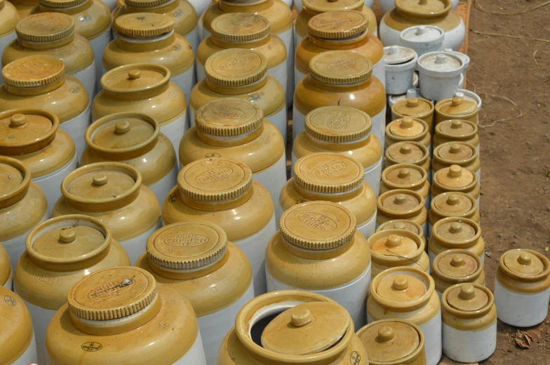 a lot of jars that are sitting on the ground, yellow ochre, spectacular quality, hegre, traditional medium