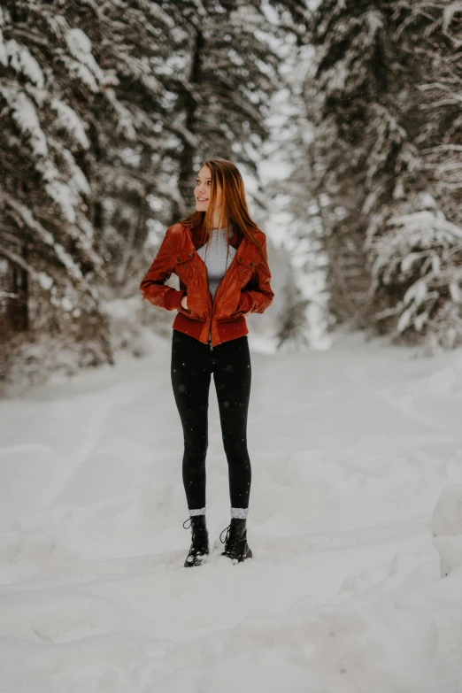 a woman standing in the snow in a red jacket, pexels contest winner, dressed in short leather jacket, kailee mandel, lush surroundings, avatar image