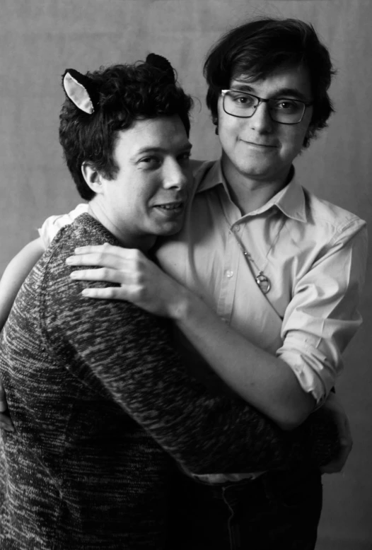 a black and white photo of two people hugging each other, by Ryan Pancoast, franz schubert look alike, transgender, greg rutowski, nerds