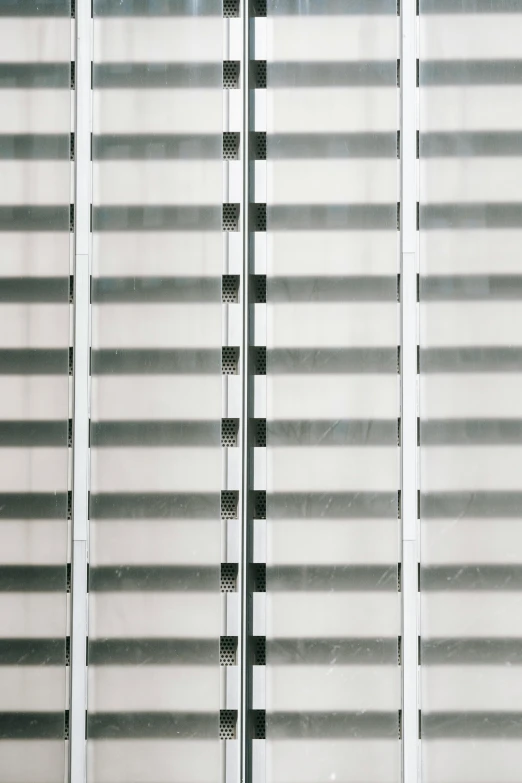 a red fire hydrant sitting in front of a tall building, an album cover, inspired by Andreas Gursky, bauhaus, soft light through blinds, grey and silver, detail structure, opaque glass