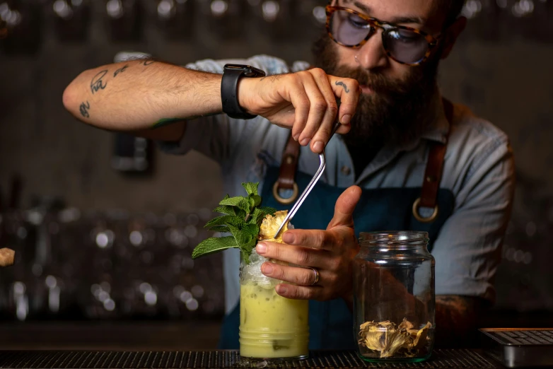a man is making a drink at a bar, a portrait, unsplash, wielding a crowbar, basil gogos, lachlan bailey, avatar image