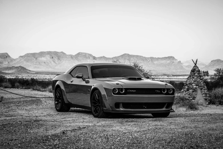 a black and white photo of a car in the desert, muscle, dark grey, diablo, thicc build