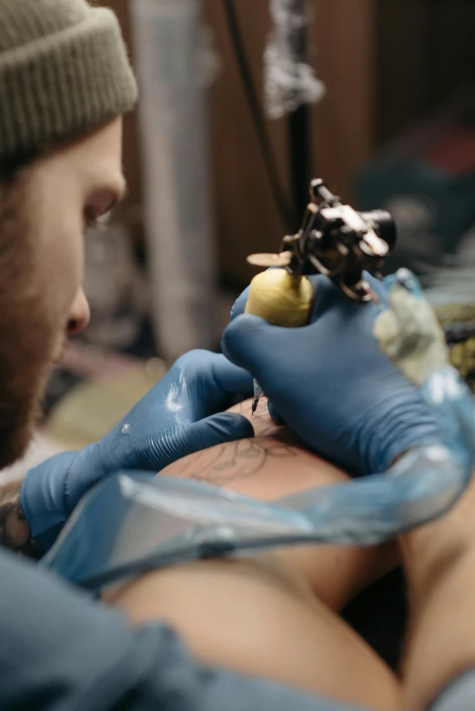 a man getting a tattoo on his arm, trending on pexels, hyperrealism, blue ink, stitching, colored, illustration »