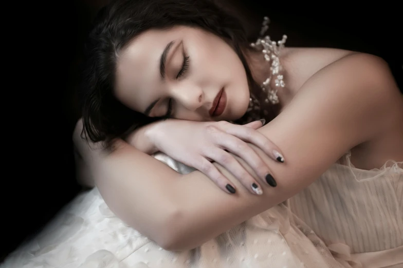 a woman that is laying down with her eyes closed, inspired by Elsa Bleda, trending on pexels, art photography, an elegant gothic princess, silver，ivory, beautiful hands, 8k artistic 1920s photography