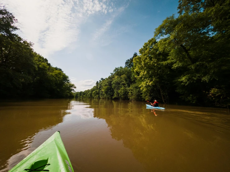 a person in a green kayak paddling down a river, by Jessie Algie, unsplash contest winner, cahaba river alabama, tan, wide view, thumbnail