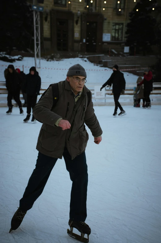 a man riding a skateboard across a snow covered park, larry david, cornell, he is dancing, mohamed chahin