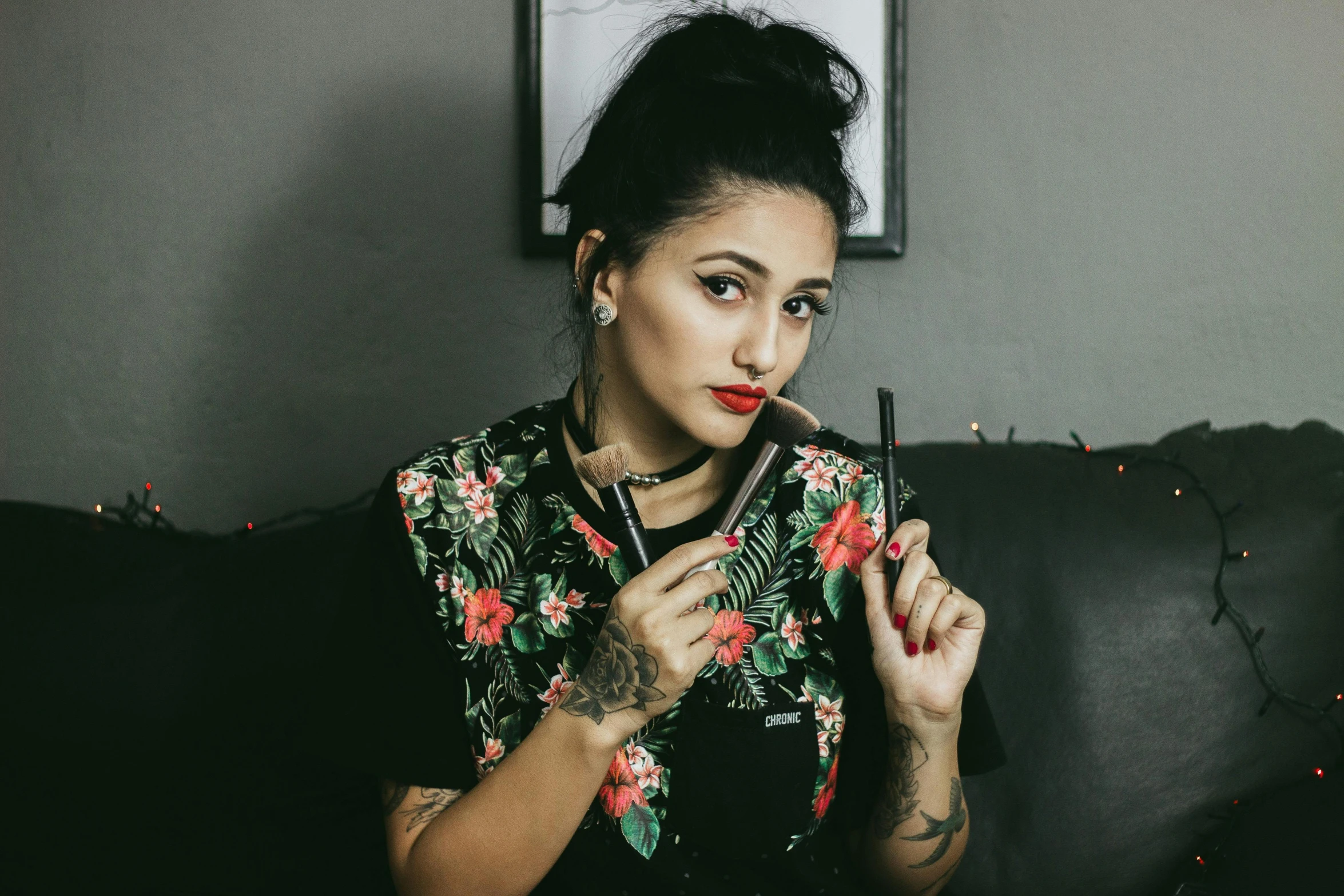 a woman sitting on a couch smoking a cigarette, a tattoo, trending on pexels, toyism, putting makeup on, floral, headshot profile picture, kyza saleem