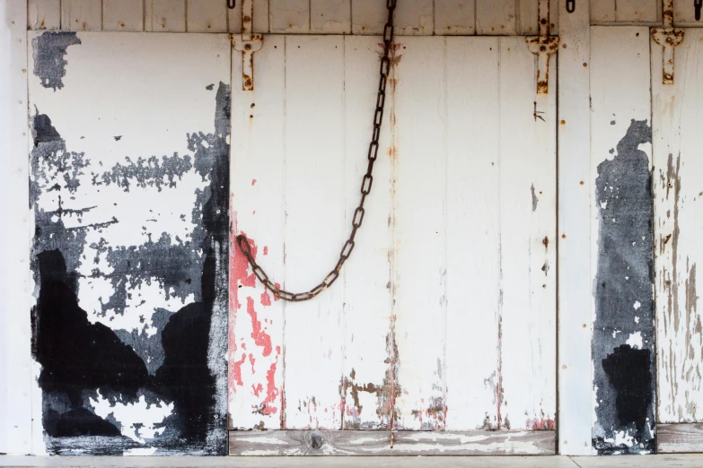 a red fire hydrant sitting on the side of a building, an album cover, unsplash, graffiti, iron arc gate door texture, ((chains)), white plank siding, antoni tapies and cy twombly