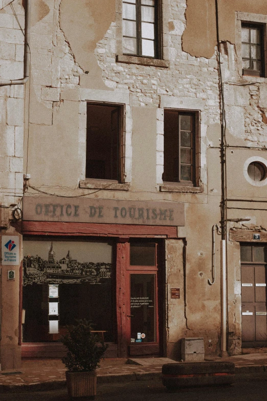 an old building sitting on the side of a street, inspired by Pierre Toutain-Dorbec, pexels contest winner, renaissance, beige, small town surrounding, office, 1990's