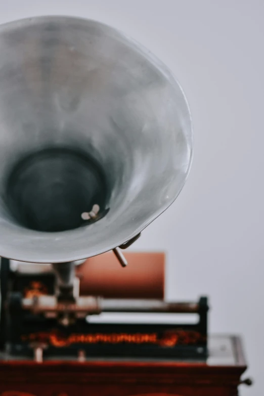 an old gramphone sitting on top of a wooden table, by Winona Nelson, trending on unsplash, kinetic art, tuba, grey, bottom body close up, cone