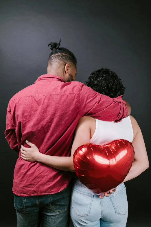 a man standing next to a woman holding a heart shaped balloon, pexels, renaissance, hugging each other, foil, she's sad, diverse