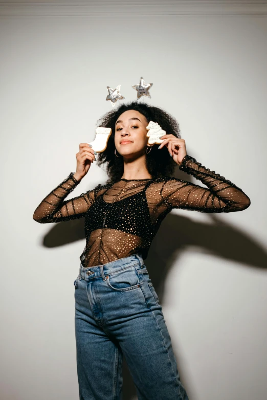 a woman with a crown on top of her head, an album cover, pexels contest winner, wearing a black bodysuit, wearing festive clothing, wearing a shirt and a jean, mixed-race woman