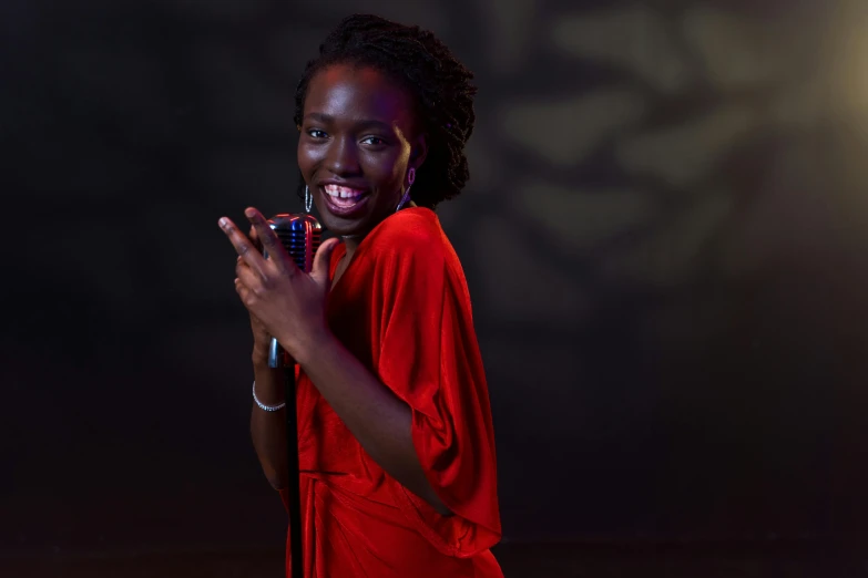 a woman in a red dress holding a microphone, by Winona Nelson, pexels contest winner, adut akech, dramatic smiling pose, black teenage girl, slide show