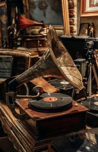 an old record player sitting on top of a table, an album cover, by Konrad Witz, trending on pexels, assemblage, 1900s photo, a steampunk store, winding horn, in the museum