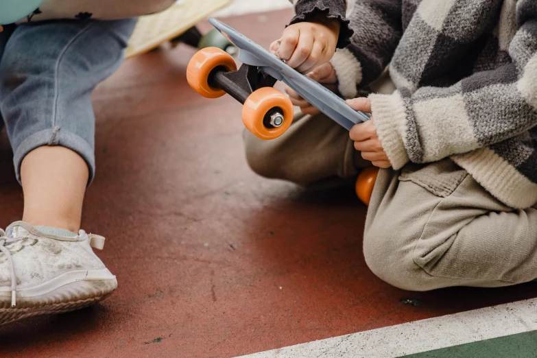 a couple of kids sitting on the ground with skateboards, pexels contest winner, carving, zoomed in, 15081959 21121991 01012000 4k, thumbnail