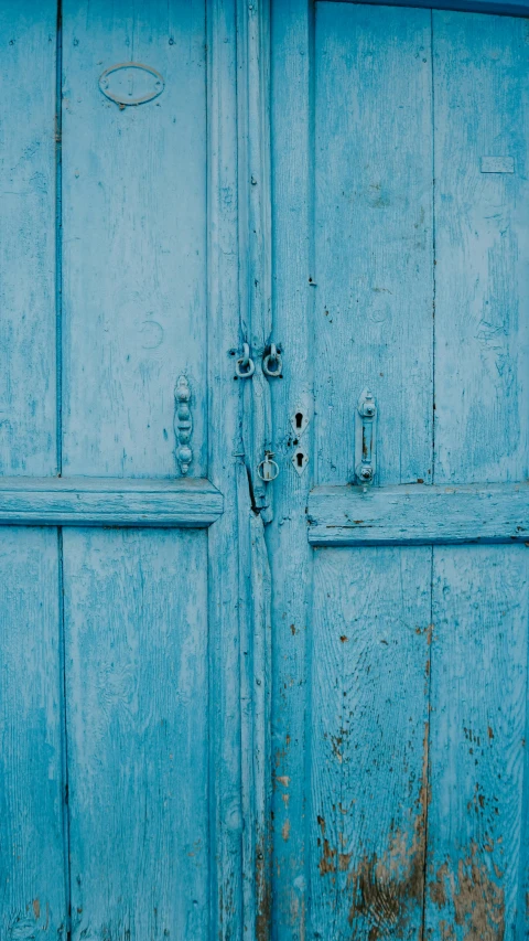 a red fire hydrant sitting in front of a blue door, an album cover, by Elsa Bleda, rustic wood, ((blue)), moroccan, pale blue