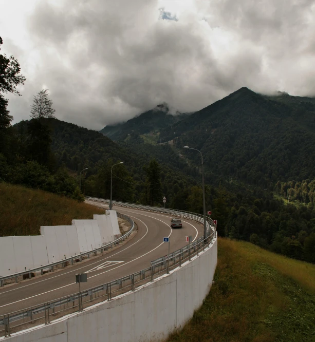 a view of a highway with mountains in the background, inspired by Peter Zumthor, renaissance, panoramic view, guardrail, thumbnail, wall