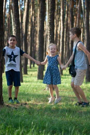 a group of children holding hands in a forest, a picture, by Ivan Grohar, hurufiyya, pine trees in the background, 15081959 21121991 01012000 4k, swings, premium quality