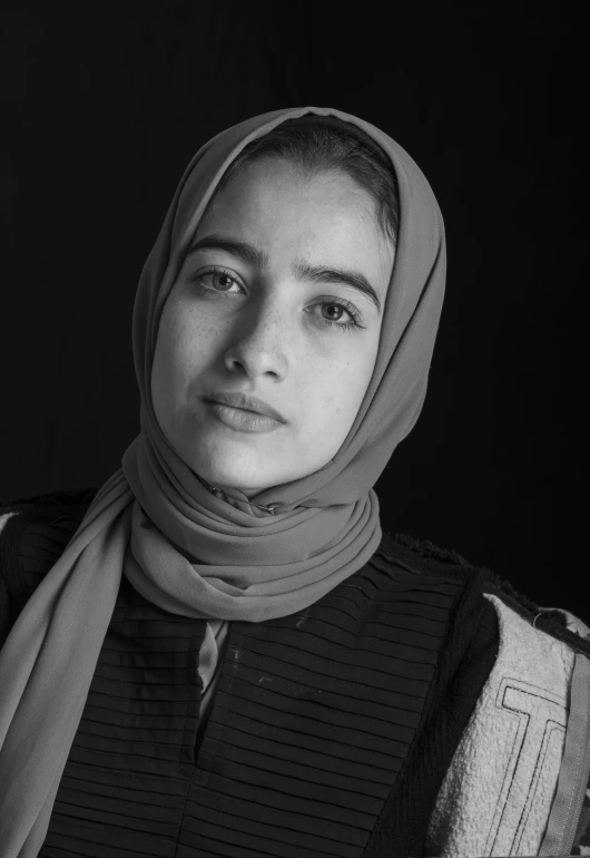 a black and white photo of a woman wearing a scarf, by Maryam Hashemi, 1 6 years old, portait photo profile picture, serious expression, 1 8