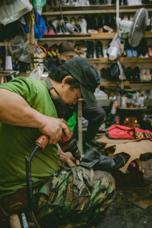 a man working in a shoe repair shop, a portrait, trending on unsplash, camo, inuit heritage, biker, slide show