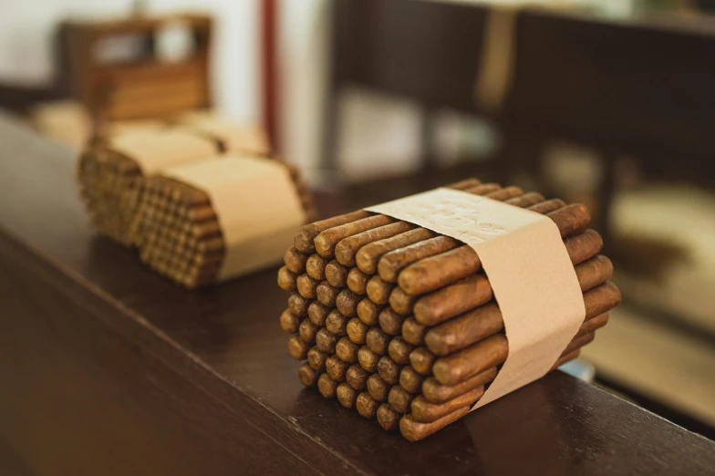 a bunch of cigars sitting on top of a table, inspired by Ceferí Olivé, brown, stacked, high quality product image”, extra detail