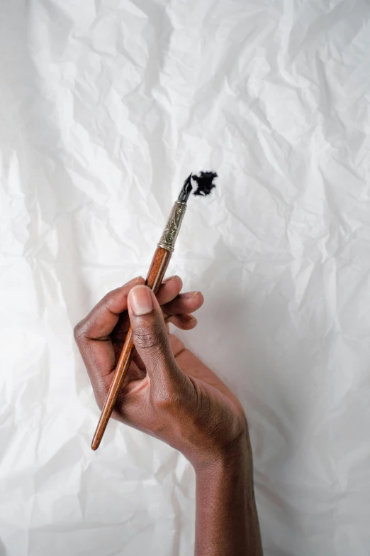 a person holding a toothbrush in their hand, a photorealistic painting, inspired by Ceferí Olivé, unsplash, kara walker, calligraphy, unstirred paint, a high angle shot