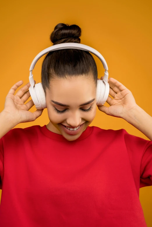 a woman in a red shirt is listening to headphones, trending on pexels, yellow and red color scheme, arcs, happy girl, diverse