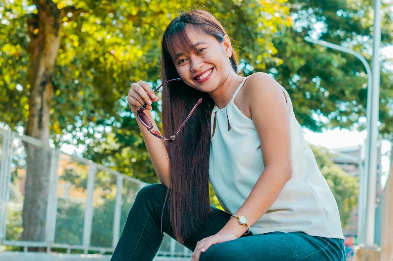 a beautiful young woman sitting on top of a skateboard, pexels contest winner, wearing small round glasses, avatar image, mai anh tran, sitting on a park bench