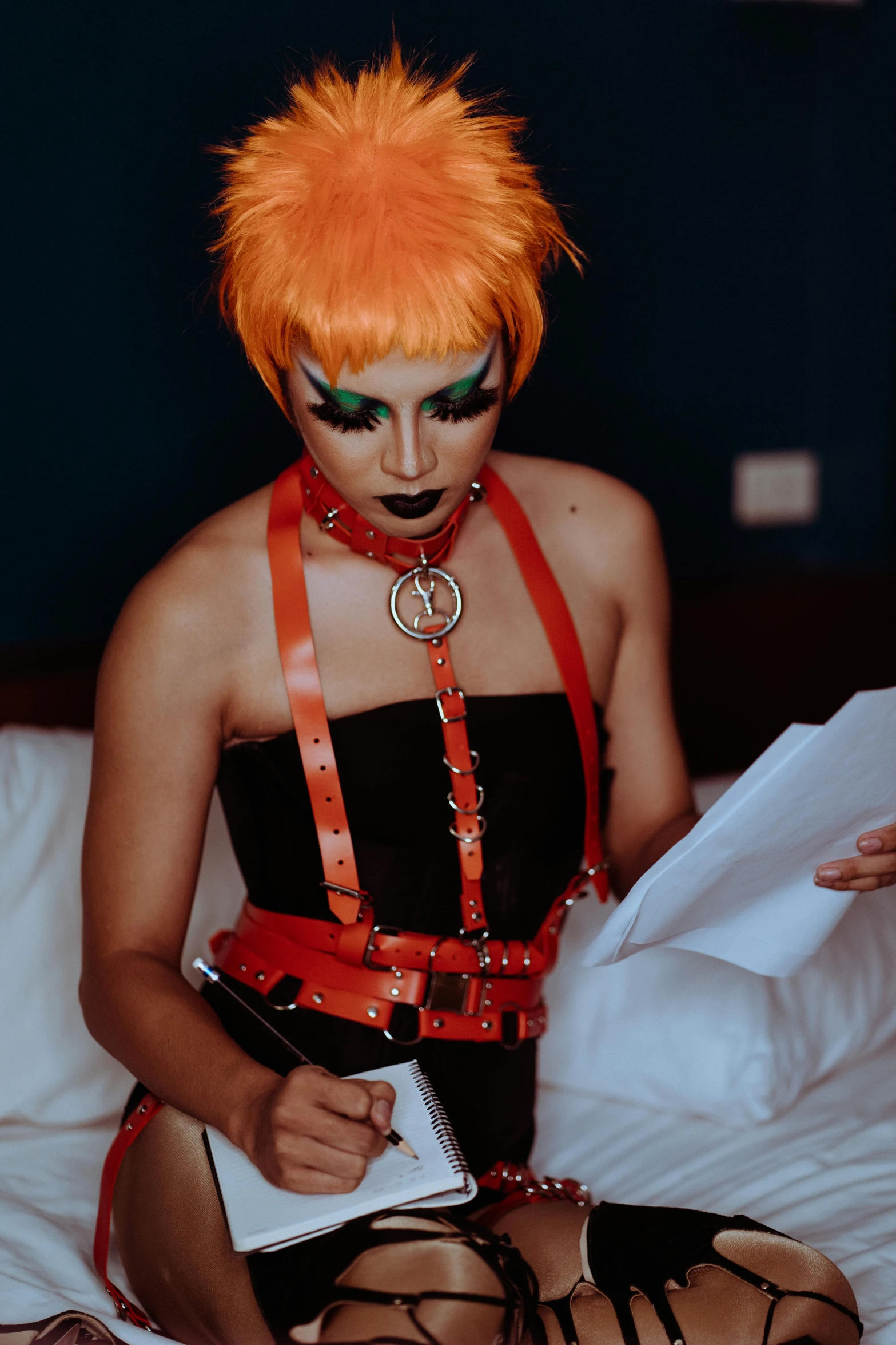 a woman with orange hair sitting on a bed, an album cover, reddit, transgressive art, black leather harness, decora inspired, cosplay photo, profile image