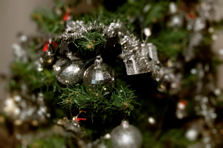 a close up of a christmas tree with ornaments, by Béla Nagy Abodi, ap photo, grey and silver, file photo, a green