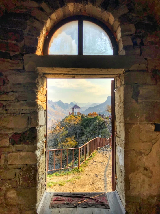 an open door with a view of the mountains, by Kristian Zahrtmann, pexels contest winner, romanesque, photo on iphone, castelvania, the panorama, middle close up composition