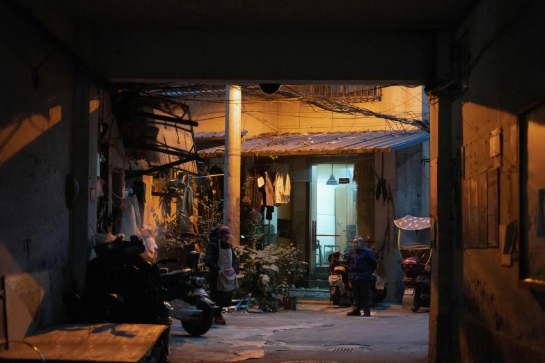 a couple of people that are standing in a room, by Daniel Lieske, pexels contest winner, arte povera, in an alley at night back lit, zezhou chen, panoramic shot, yard