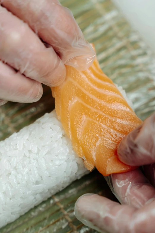 a close up of a person holding a piece of fish, fruit, fish tail, sharpen, bao phan