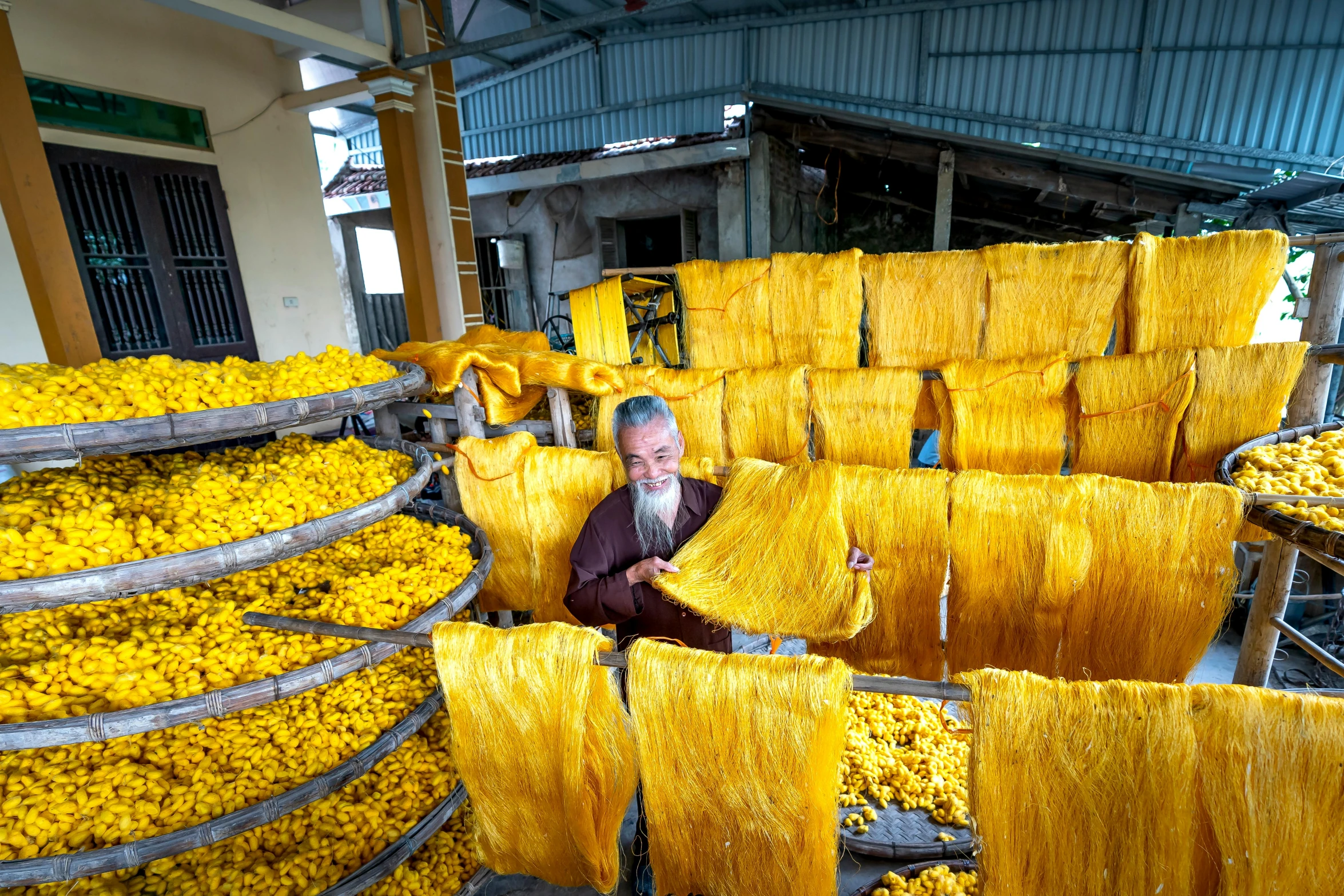 a man that is standing in front of a bunch of bananas, process art, silk flowing in wind, mustard, small manufacture, thumbnail