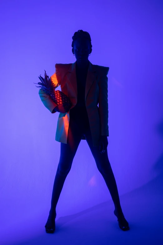 a woman standing in front of a purple background, inspired by Bert Stern, unsplash, afrofuturism, full body backlight, blue and orange lighting, girl in suit, on a mannequin. studio lighting