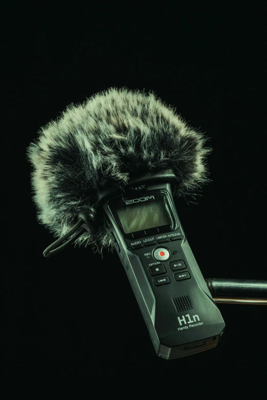 a close up of a cell phone with a microphone attached to it, by Niko Henrichon, hurufiyya, dramatic cinematic detailed fur, promo image, instrument, timelapse