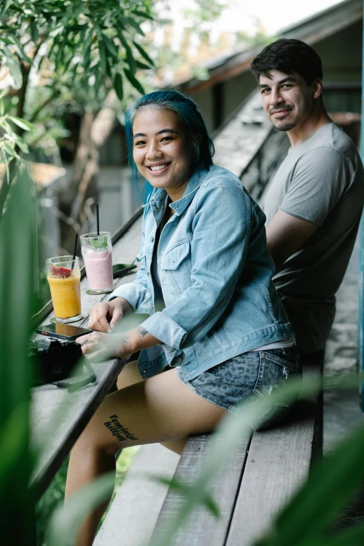 a man and a woman sitting next to each other, pexels contest winner, pretty girl with blue hair, juice, bali, casually dressed